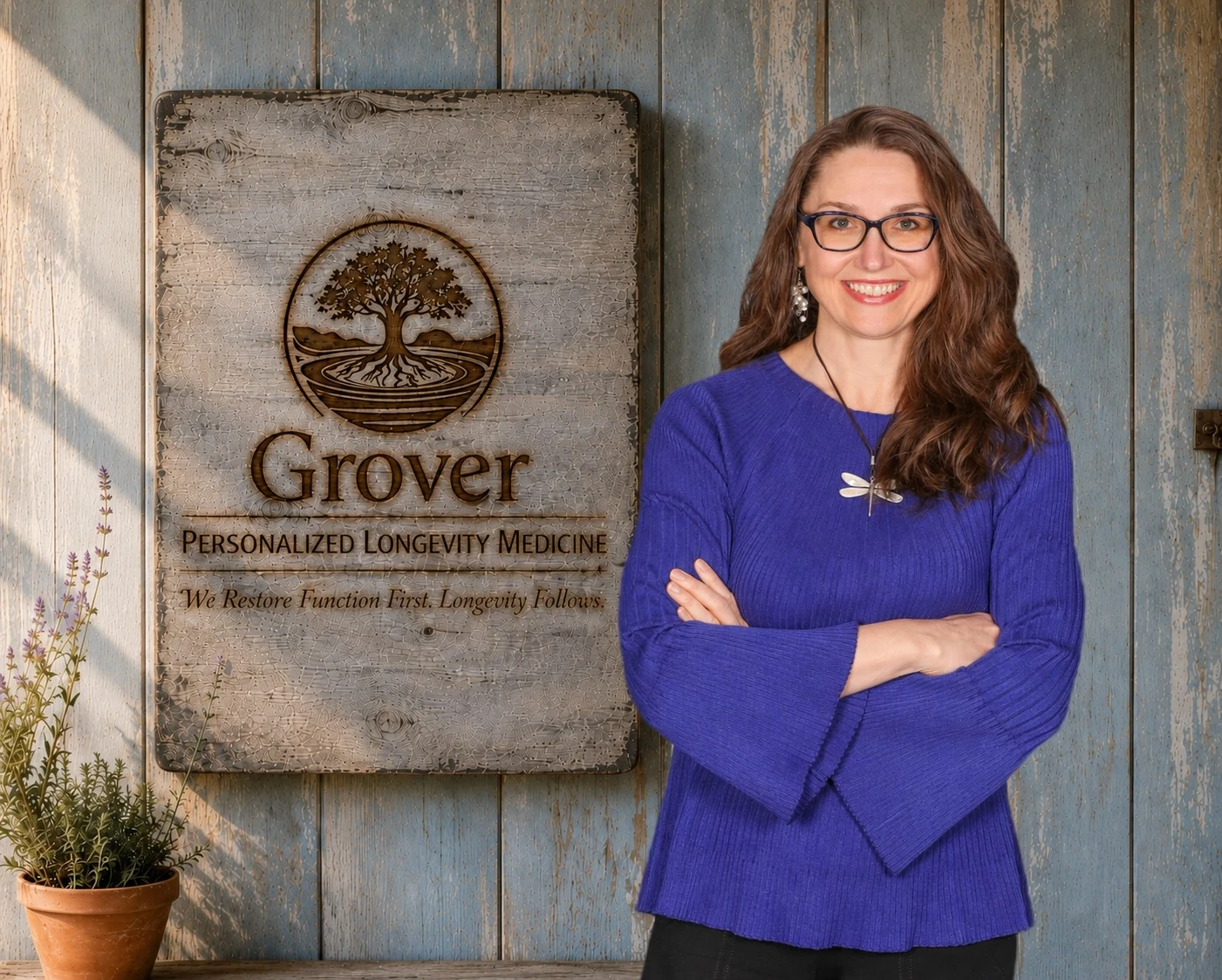 Dr. Pamela Grover beside the Grover Personalized Longevity Medicine signage on a rustic painted wood wall